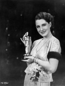 Norma Shearer holds her Oscar for Best Actress.