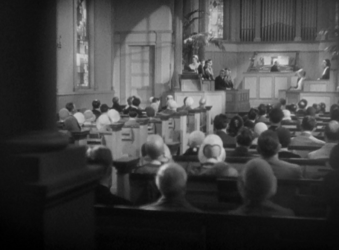 The early shots of Fallon in her father's church do some interesting things, often looking up at her to give her the illusion of power. Here we see her from the back of the church, almost lurking behind a pillar. Her anger and sadness is so palpable here, the camera almost seems to want to run away from its power.