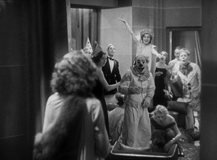 Stanwyck walks in on the carnie party to discover them openly mocking her routine. Capra openly compares her work to that of the carnival workers who hold themselves above their audience and fleece them with glee. This shot shows Stanwyck on the outside seeing how awful this looks from the outside, and she's about to be drawn in... 