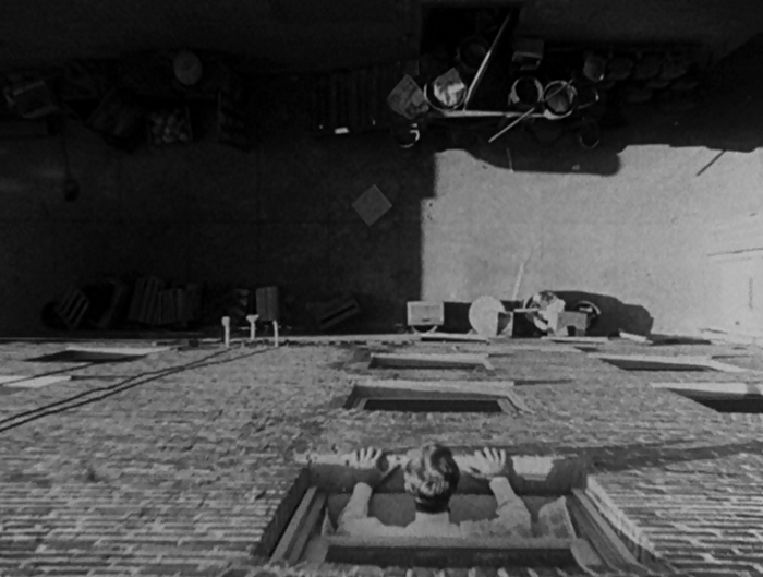 This is our first shot of John as he contemplates ending his life. What I like about this perspective is A) how mundane the alley he's considering jumping into is, and B) that we're looking down below, but at this point in the movie, we don't know that John is blind. So we're looking at the plain mundane sadness he's contemplating, but with information the character doesn't have. 